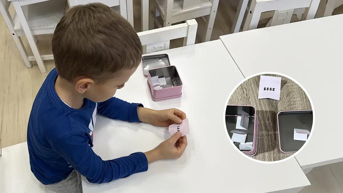 дете седнало на маса чете от лист