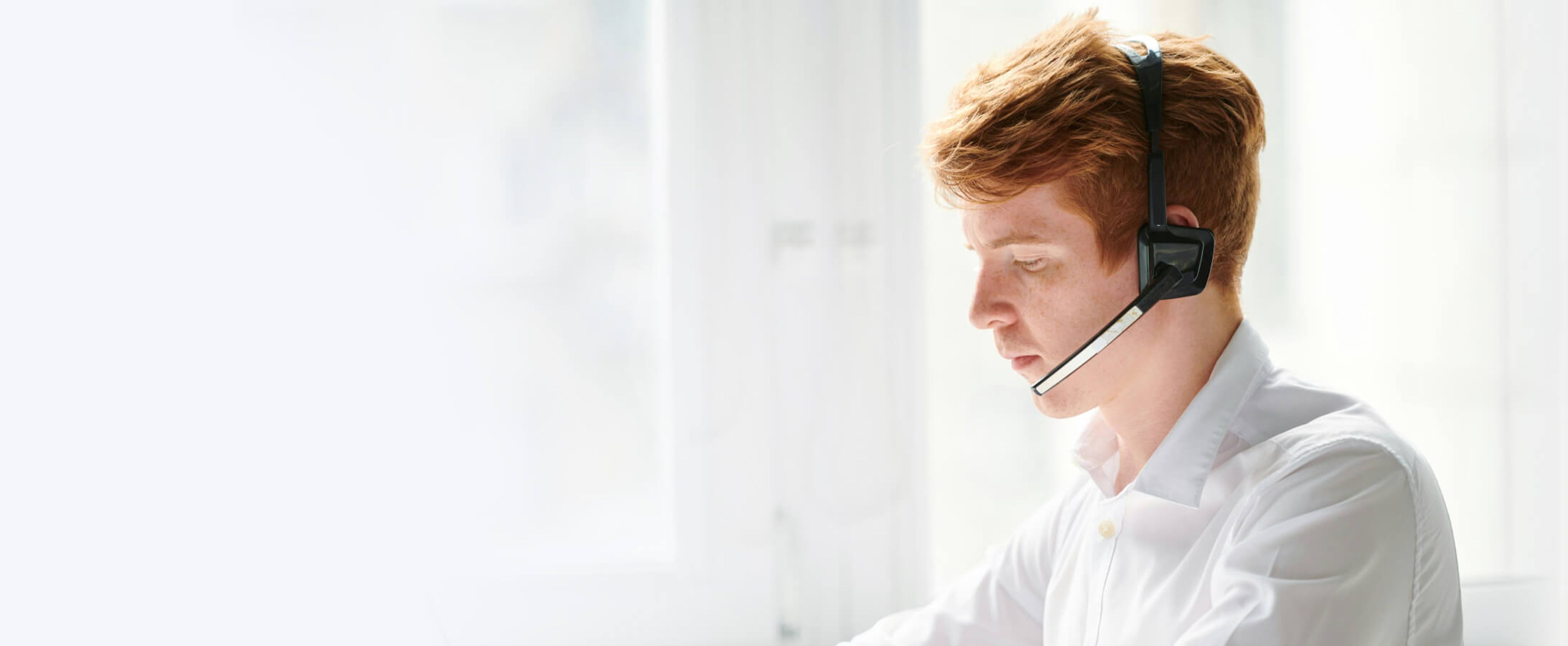 Customer support agent with headset assisting remotely, representing responsive customer service available for delivery inquiries and real-time tracking support.