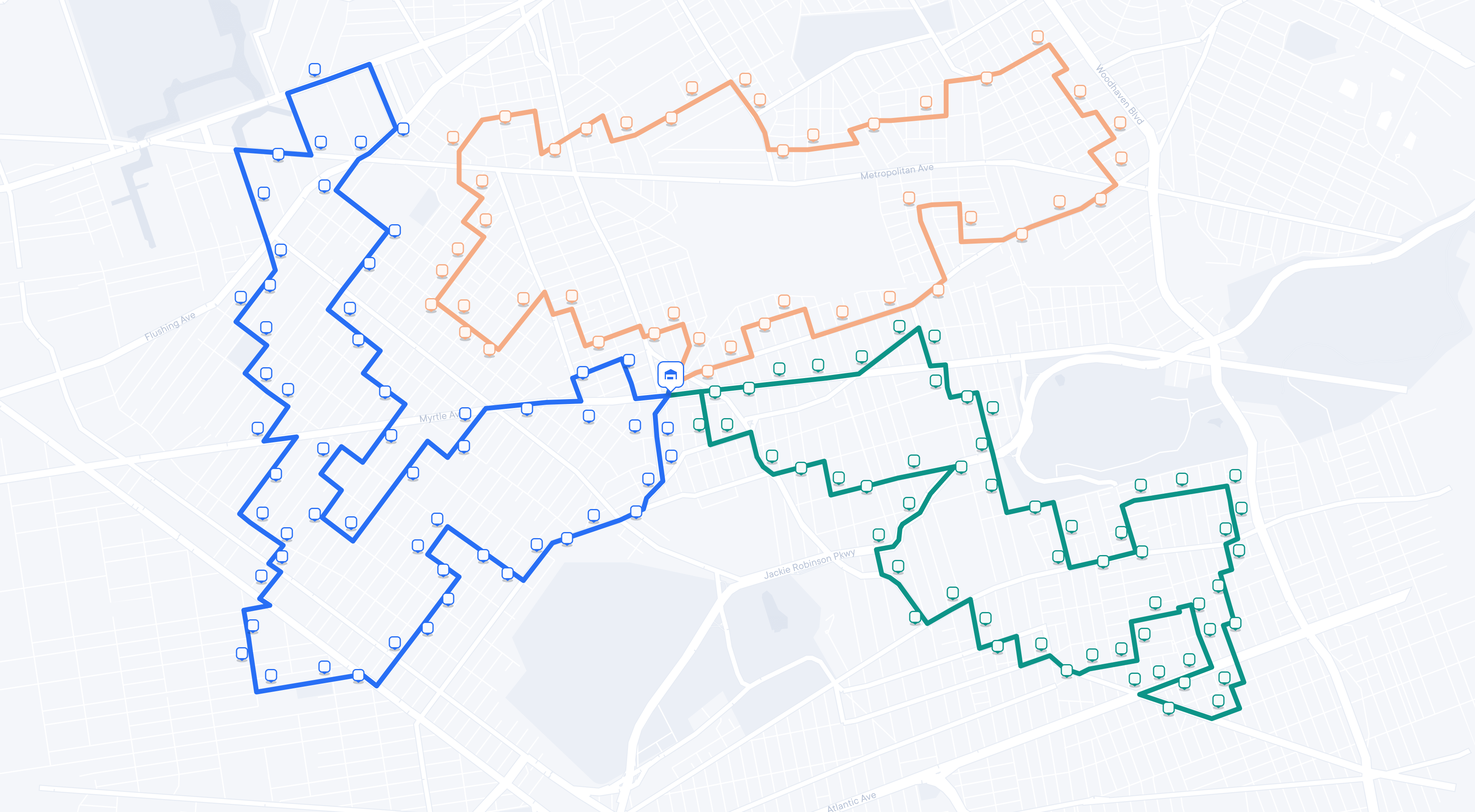 A city map similar to the first image, now displaying three distinct delivery routes in different colors: blue, orange, and green. Each colored line connects a series of square icons representing stops along the route, all originating from the central depot icon. The map visualizes optimized routing paths for deliveries.