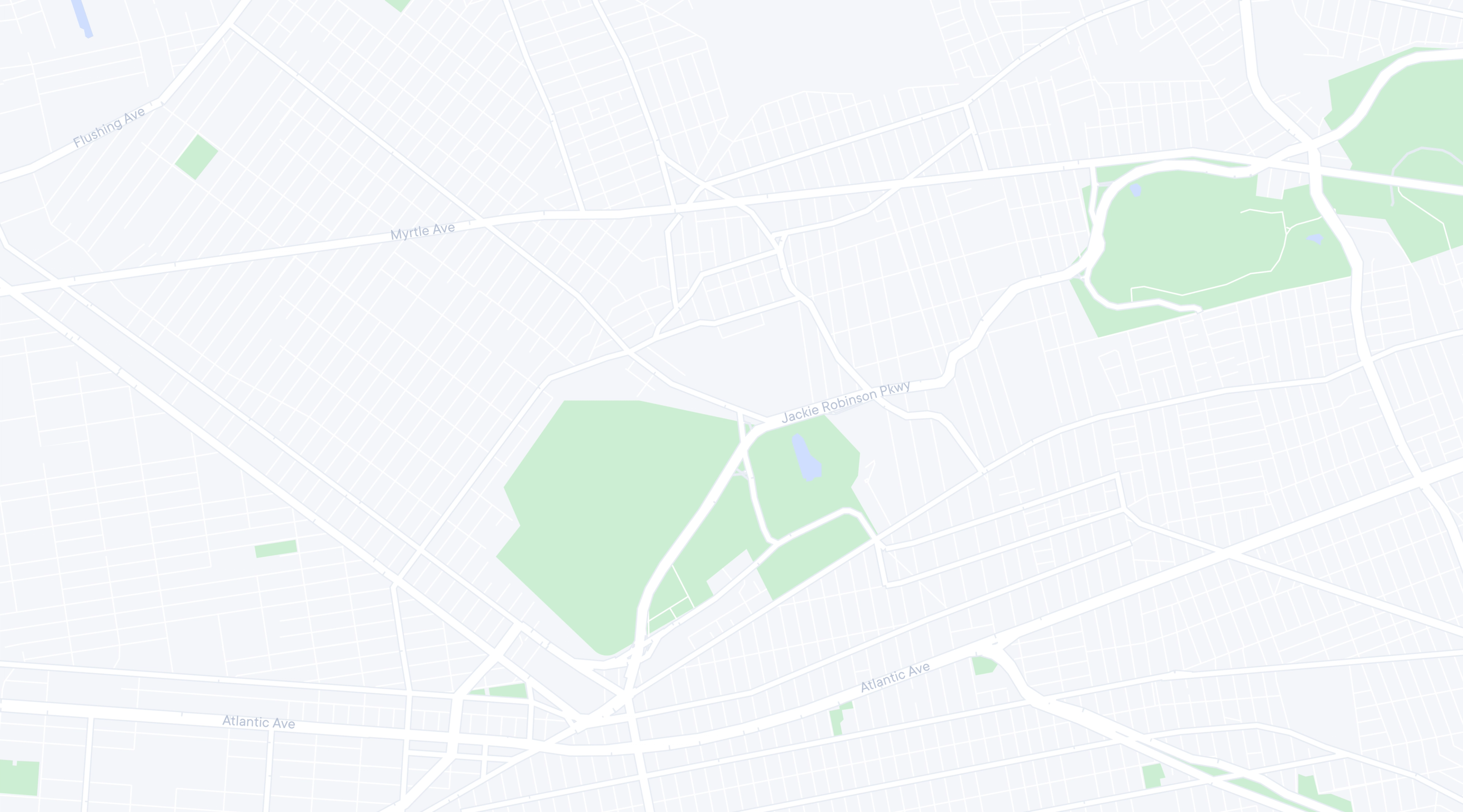 A muted map of a city area showing white roads and light green parks with labeled streets like Myrtle Ave and Jackie Robinson Pkwy.