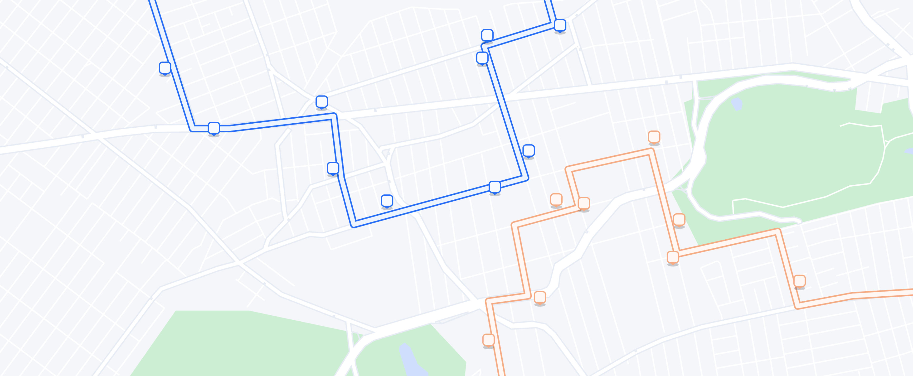 Map view of two delivery routes, one in blue and one in orange, each marked with waypoints forming distinct paths through a neighborhood and around a large park area.