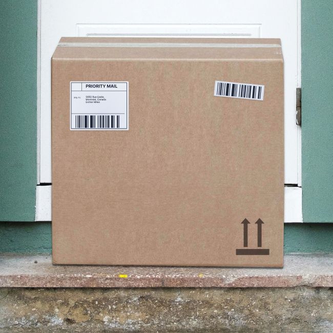 A brown cardboard box sits on a doorstep.