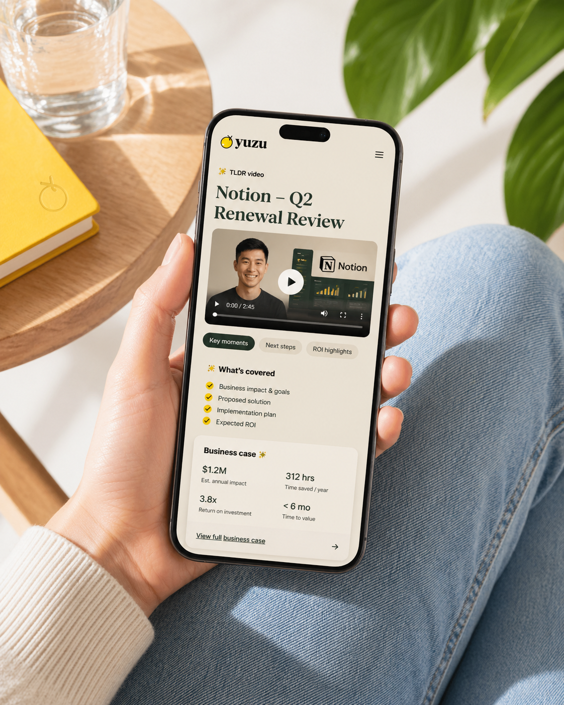A Yuzu TLDR page on a mobile phone with video, key moments, next steps, and ROI highlights