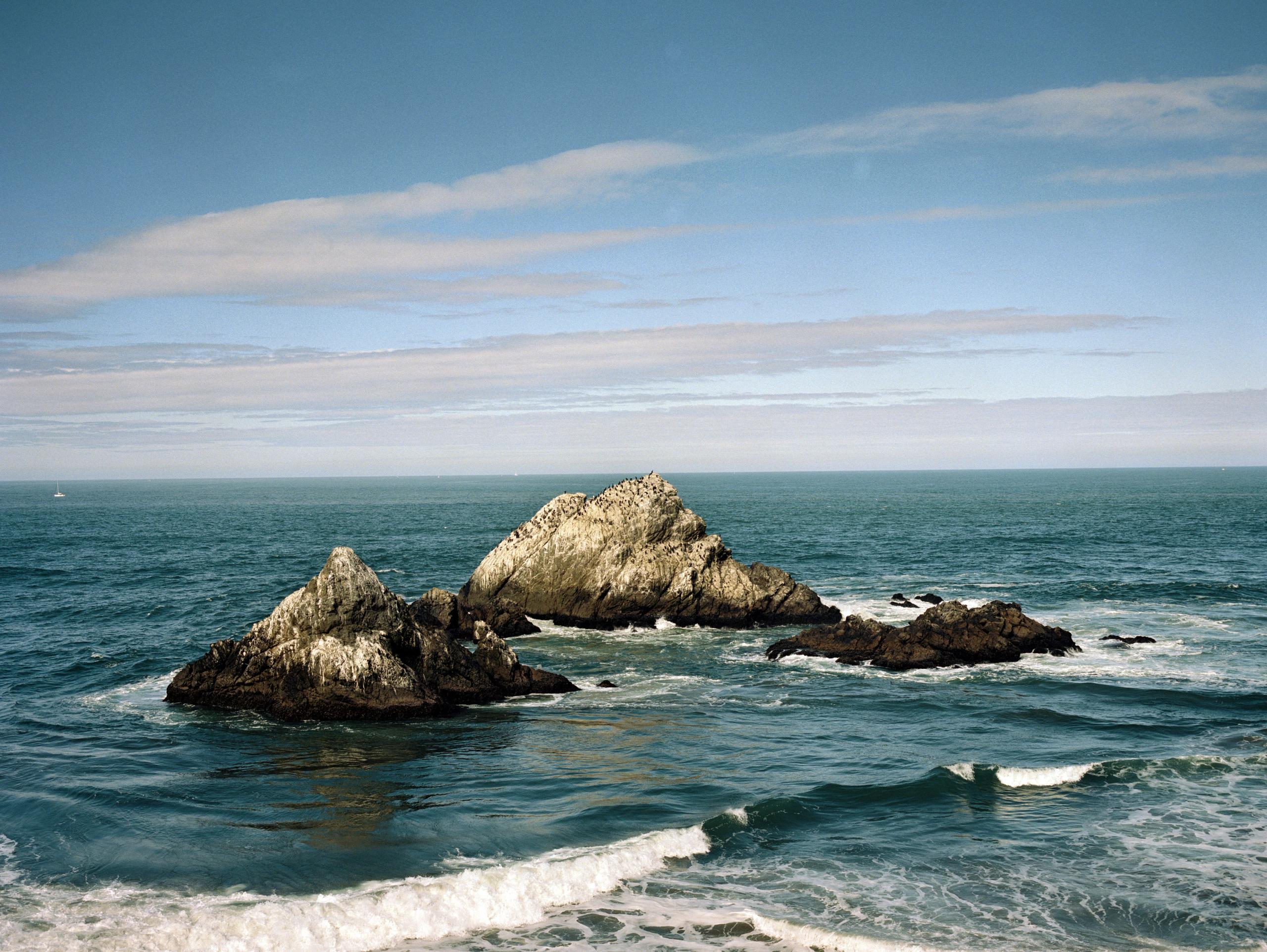 Seal Rocks rising from blue-green surf off the San Francisco coast