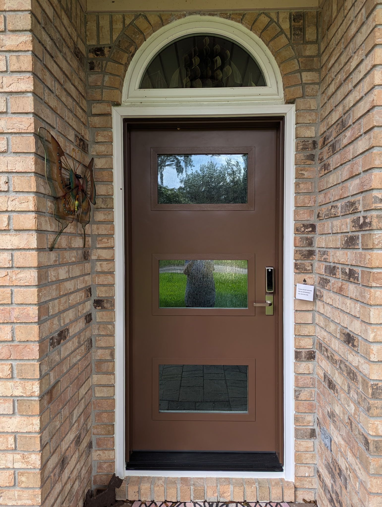 A renovated entry door on a brick house