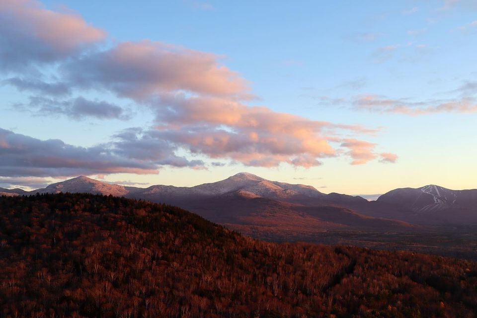 A skyline view of the White Mountains with the reddish sunset light.