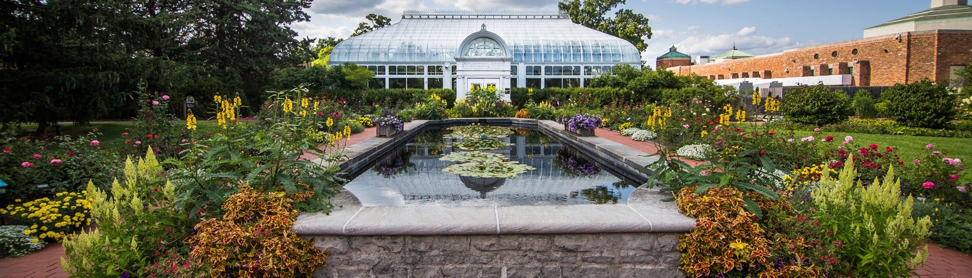 A beatiful garden and fountain in front of the Toledo Zoo's conservatory.