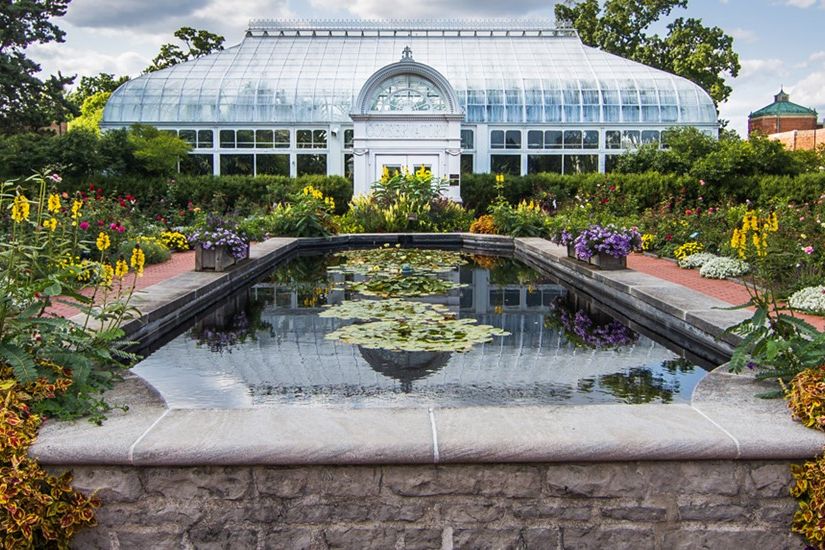 A beatiful garden and fountain in front of the Toledo Zoo's conservatory.