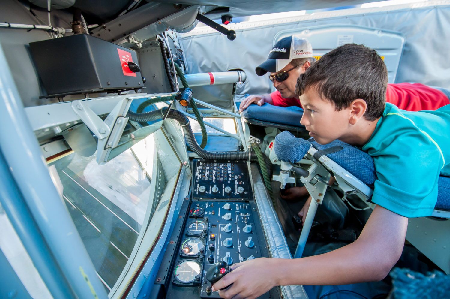 Child interacting with an airplane console display.