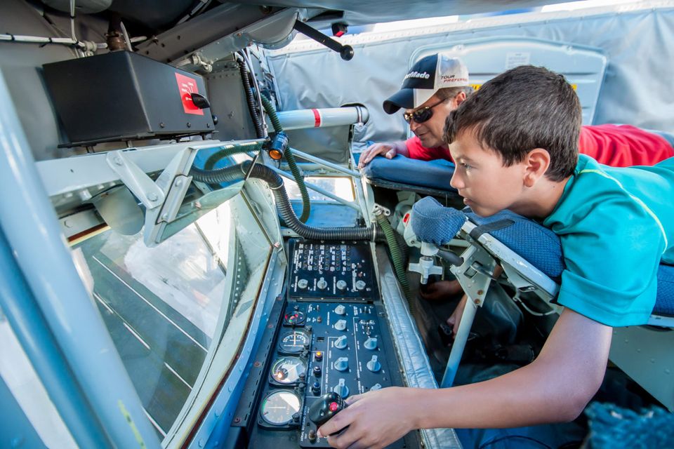 Child interacting with an airplane console display.