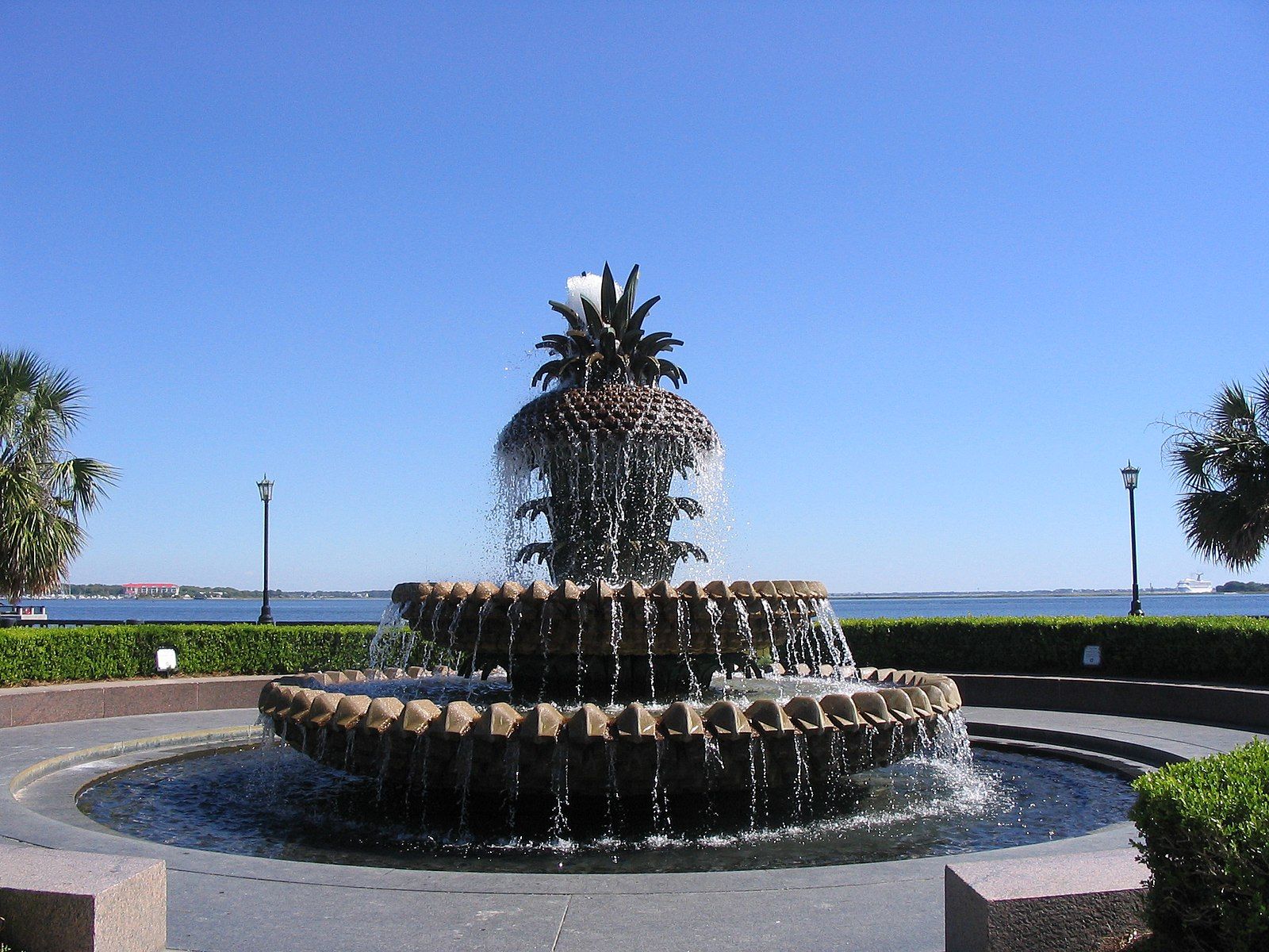 The Pineapple Fountain in front of the ocean.