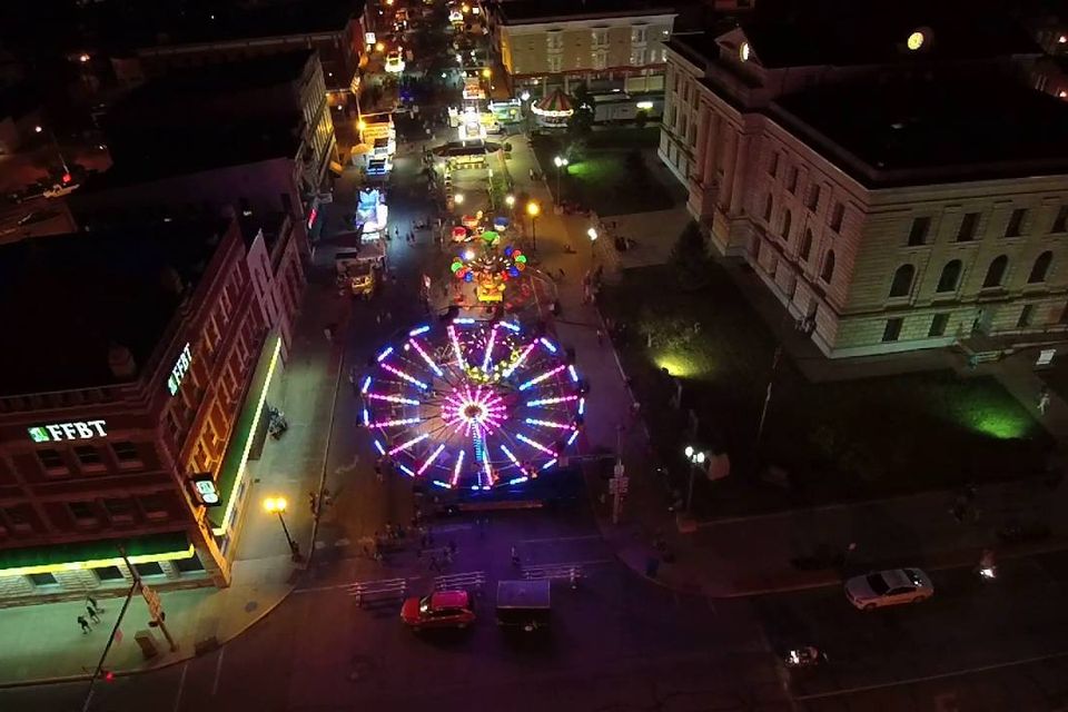 An overlook of lights from the circus and rides in the city.