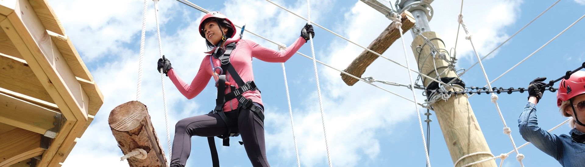 A girl climbing the Toledo Zoo's Aerial Adventure Course.