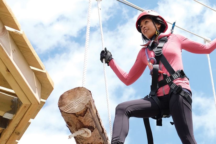 A girl climbing the Toledo Zoo's Aerial Adventure Course.