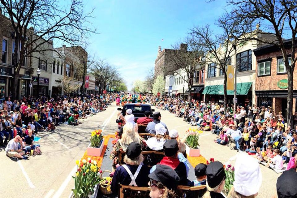 Crowds lined up on both sides of the street watching a Tulip Time parade.