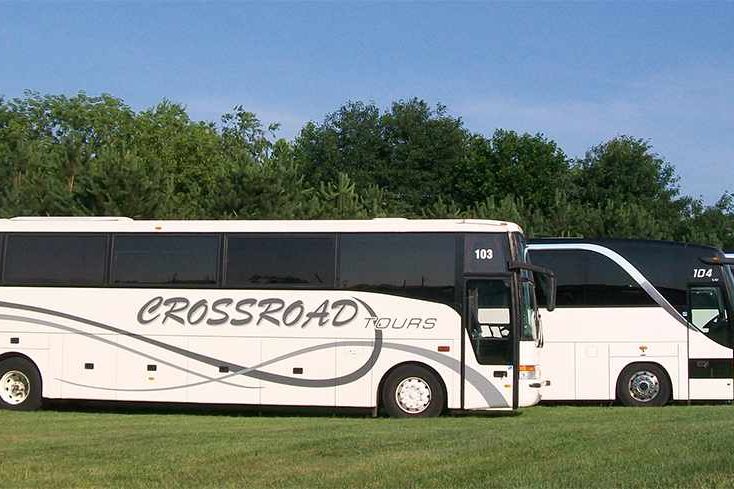 Three Crossroad Tours buses line up.