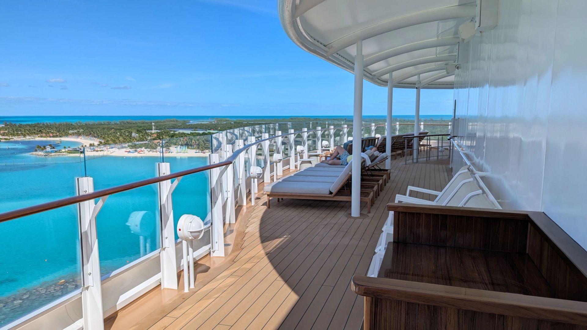 Quiet Cove adults-only pool deck on Disney Destiny with sun loungers and panoramic Caribbean ocean view