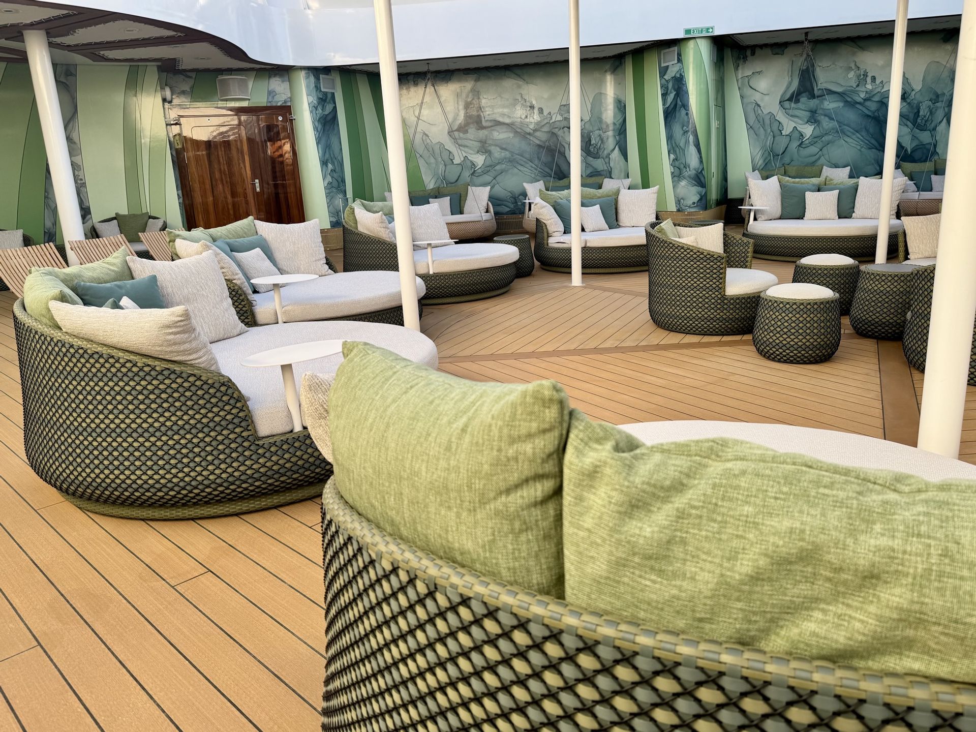 BLOOM woven daybeds and swivel armchairs with green cushions on the Senses Spa Rainforest Room outdoor terrace