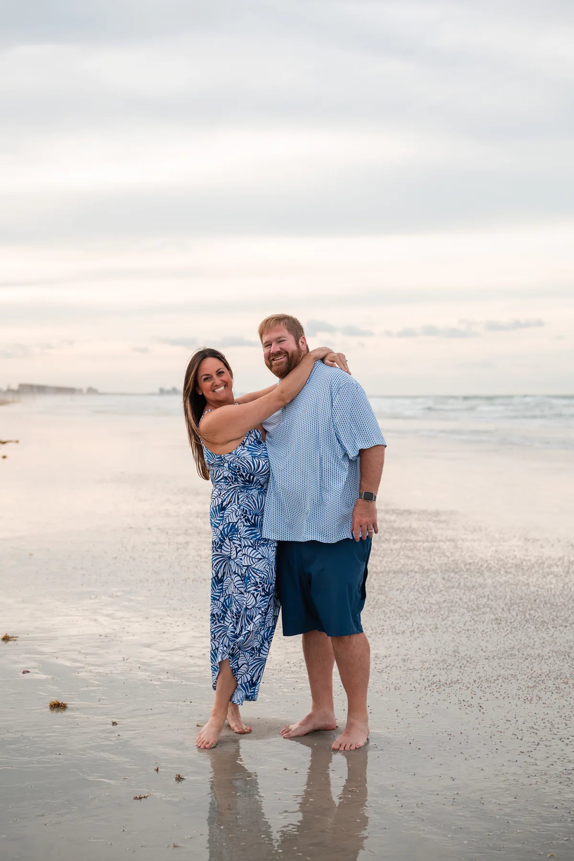 Couple standing together on the shoreline during a Ponce Inlet Beach photography session.