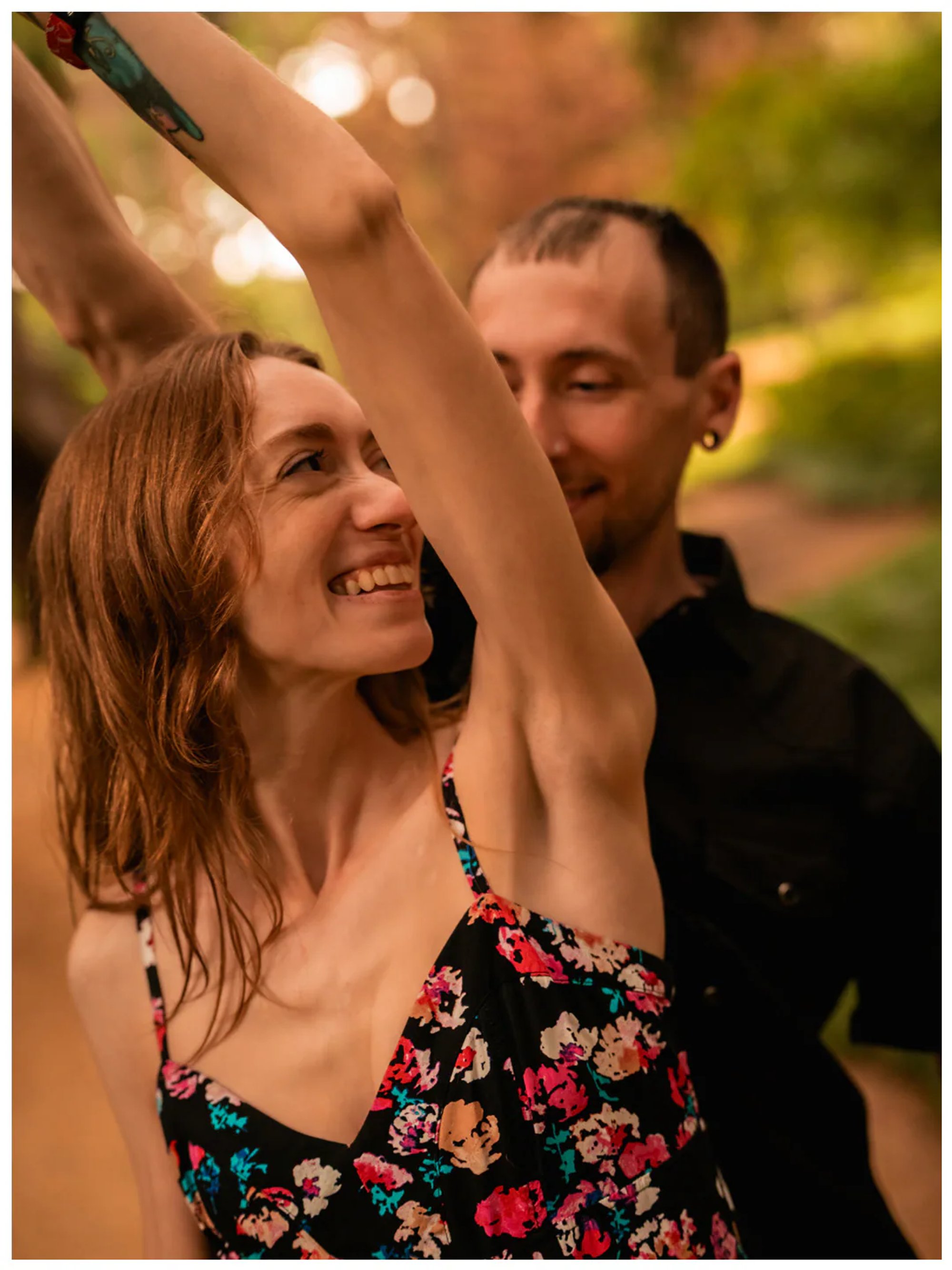 Woman smiling while being twirled by her partner during a Washington Oaks Gardens photo session.
