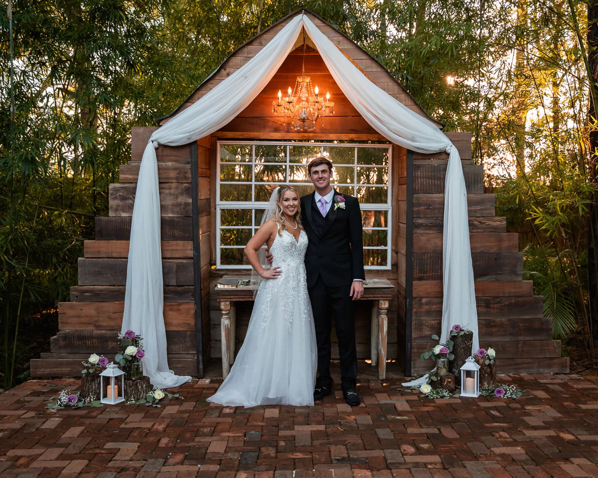 Bride and groom portrait in front of rustic chapel backdrop at Bridle Oaks Barn in DeLand Florida