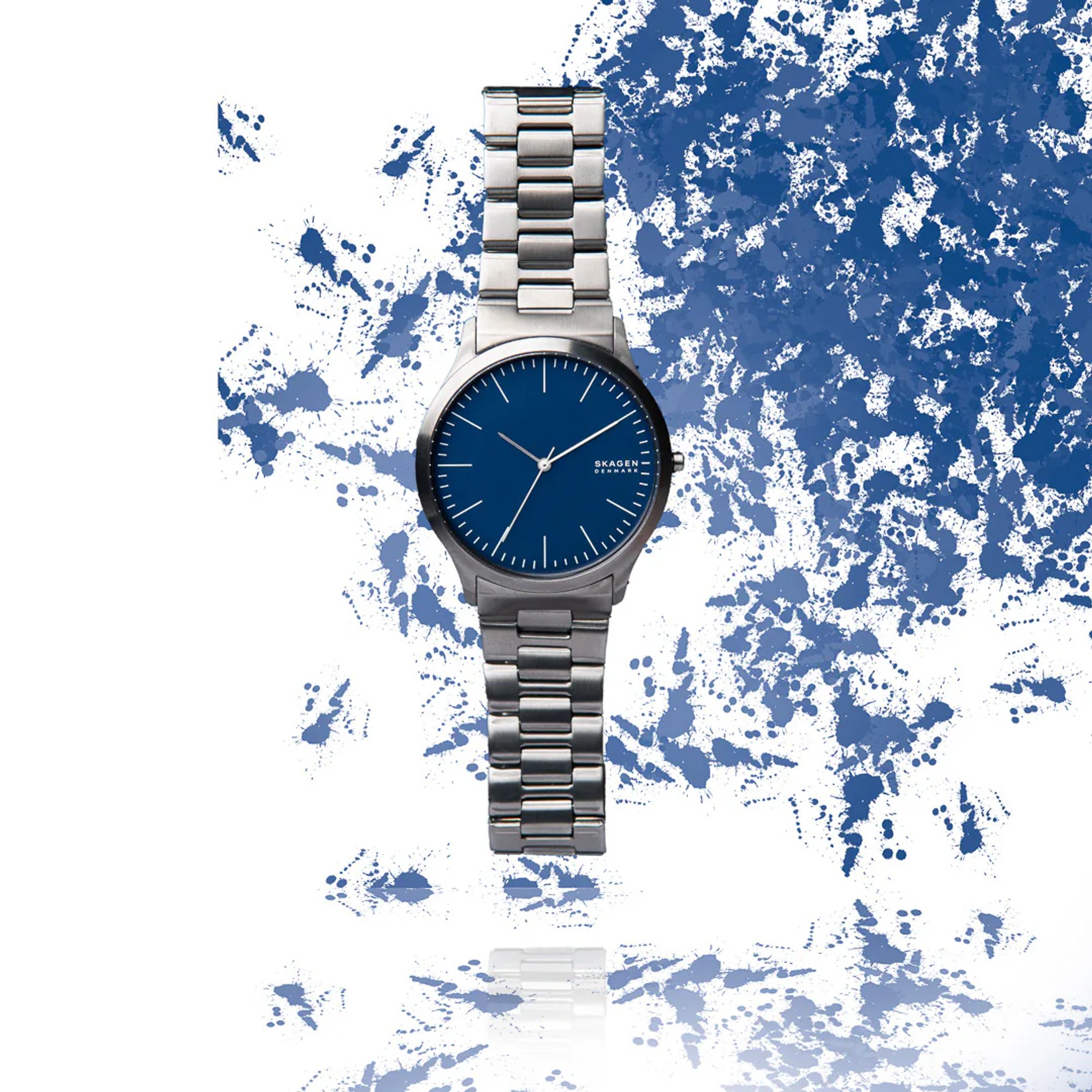 Blue-faced silver wristwatch surrounded by blue-and-white paint texture.