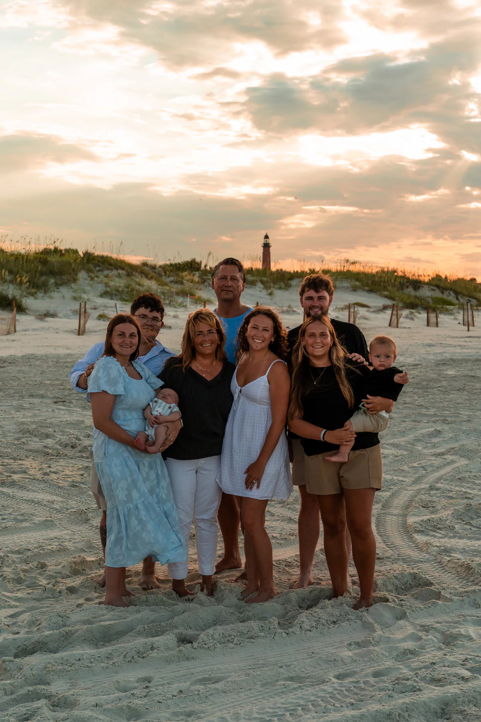 Extended family portrait on the beach with Ponce Inlet Lighthouse in the background.