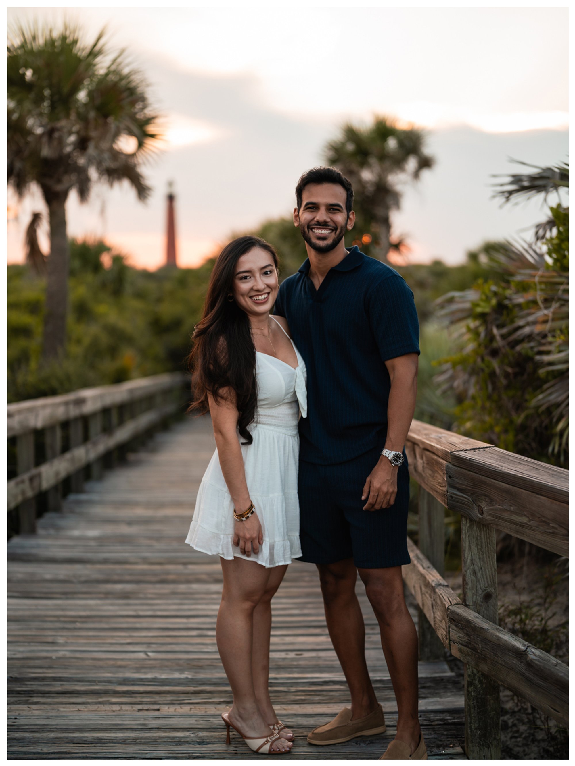 Dierick and Paulina posing on the boardwalk with the Ponce Inlet Lighthouse in the distance.