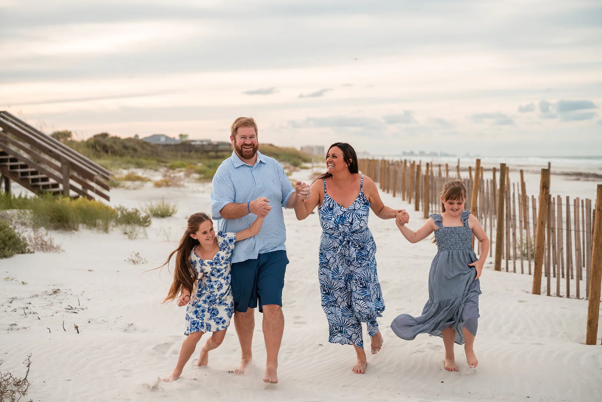 Family walking through the sand during a Ponce Inlet Beach family photo session.
