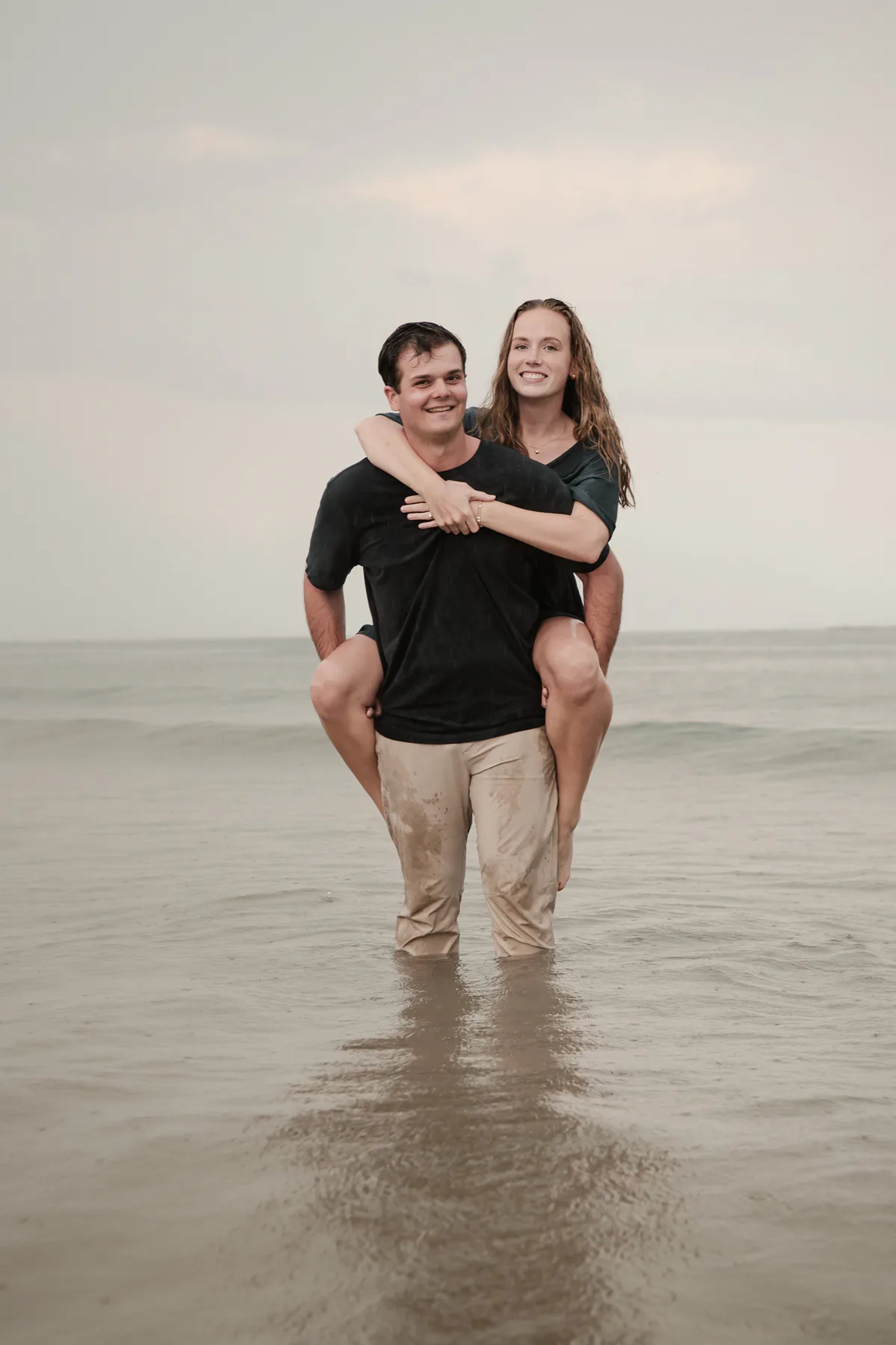 Playful beach engagement photo of couple in the water at Ponce Inlet Florida