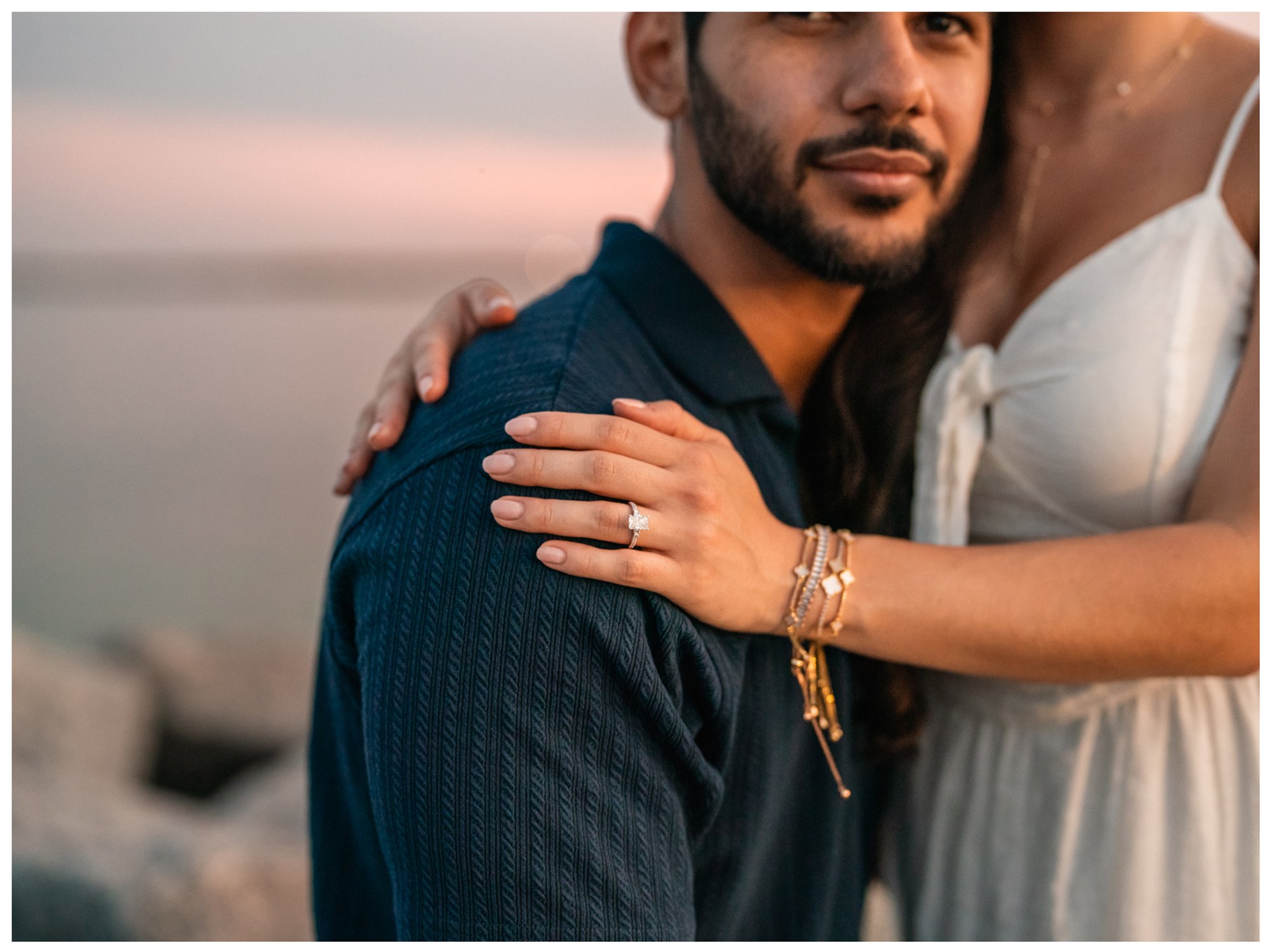 Close-up of Paulina’s engagement ring and hand resting on Dierick’s shoulder.
