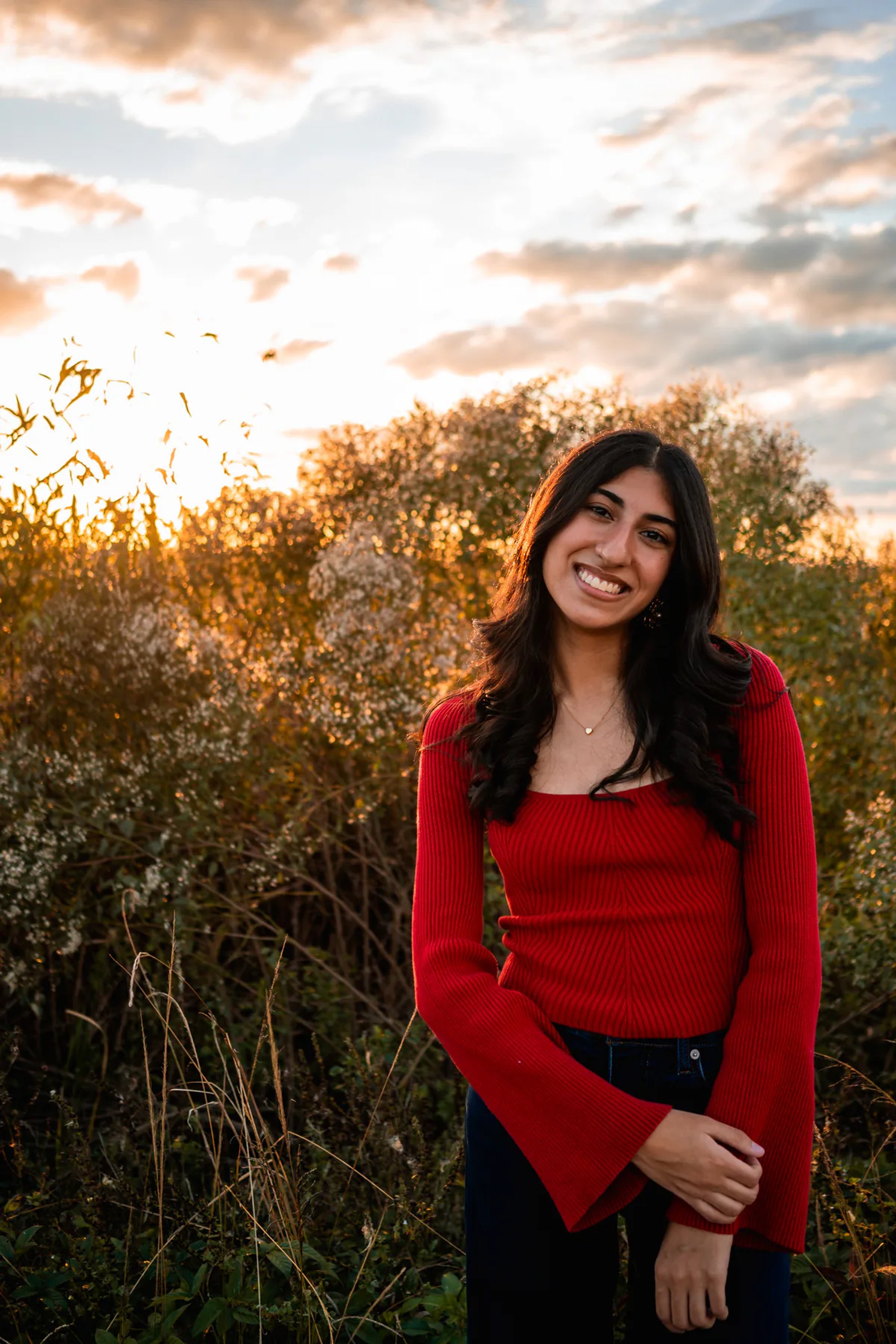 Ahaana in a red sweater for outdoor senior portraits at Lake Woodruff