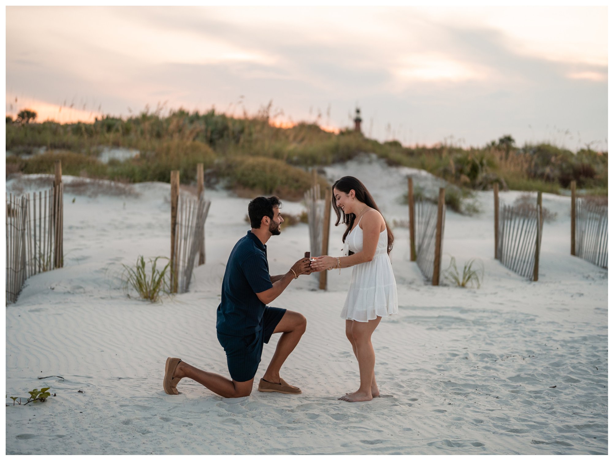 Paulina reaching toward Dierick during their surprise proposal at Lighthouse Point Park.
