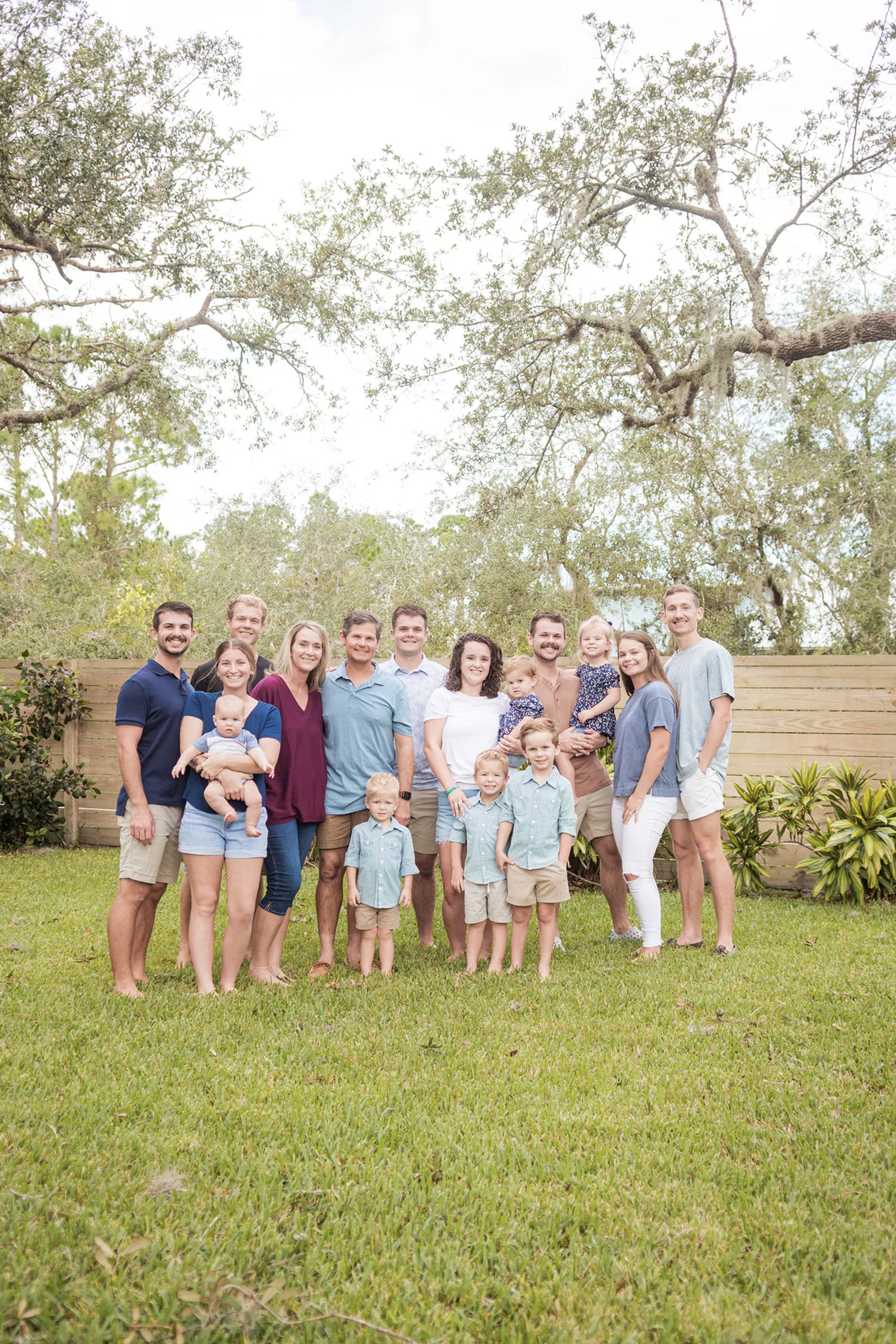 Extended family gathered beneath a sprawling live oak tree.