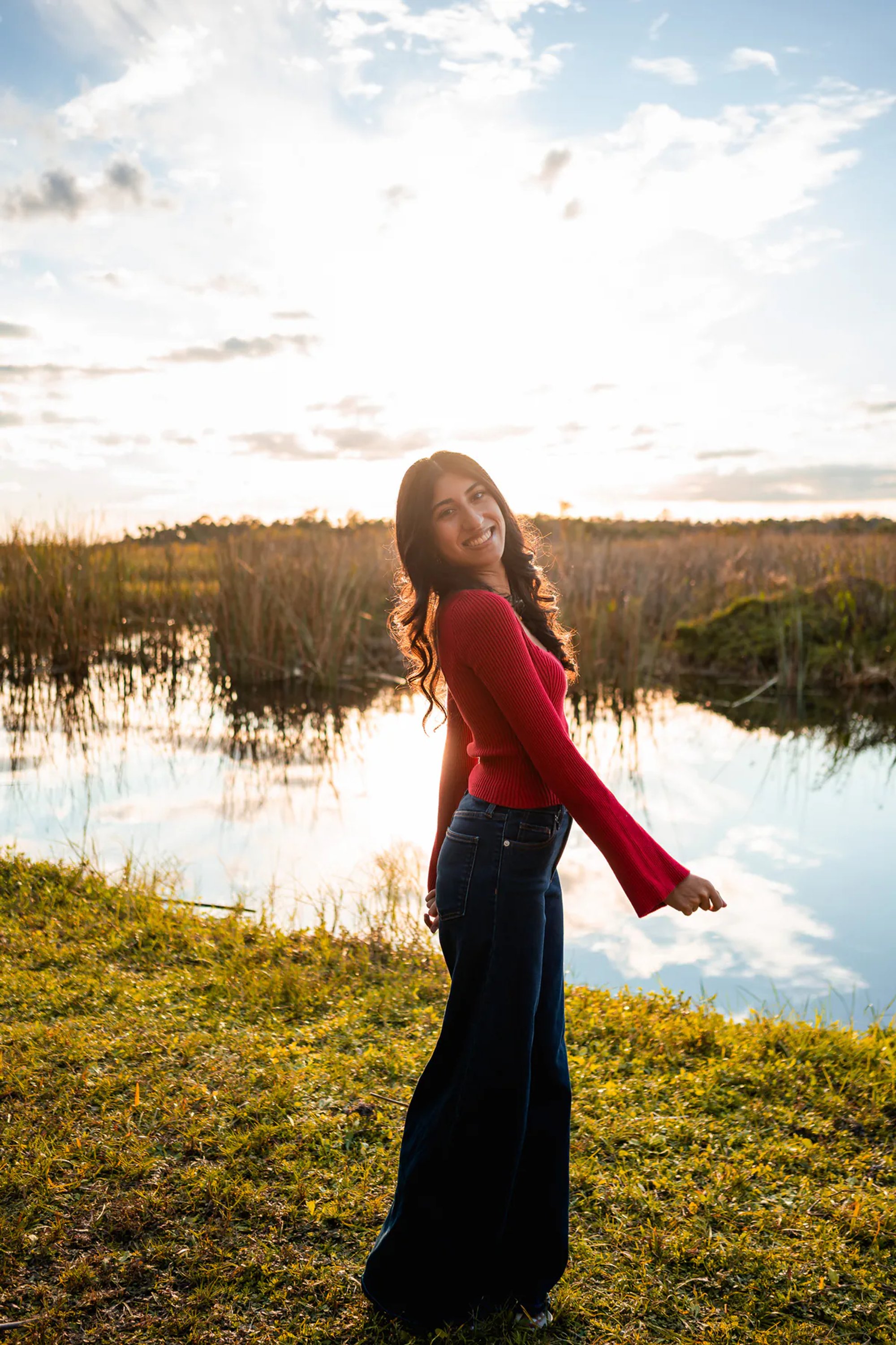Ahaana walking near the water during a Lake Woodruff senior photo session