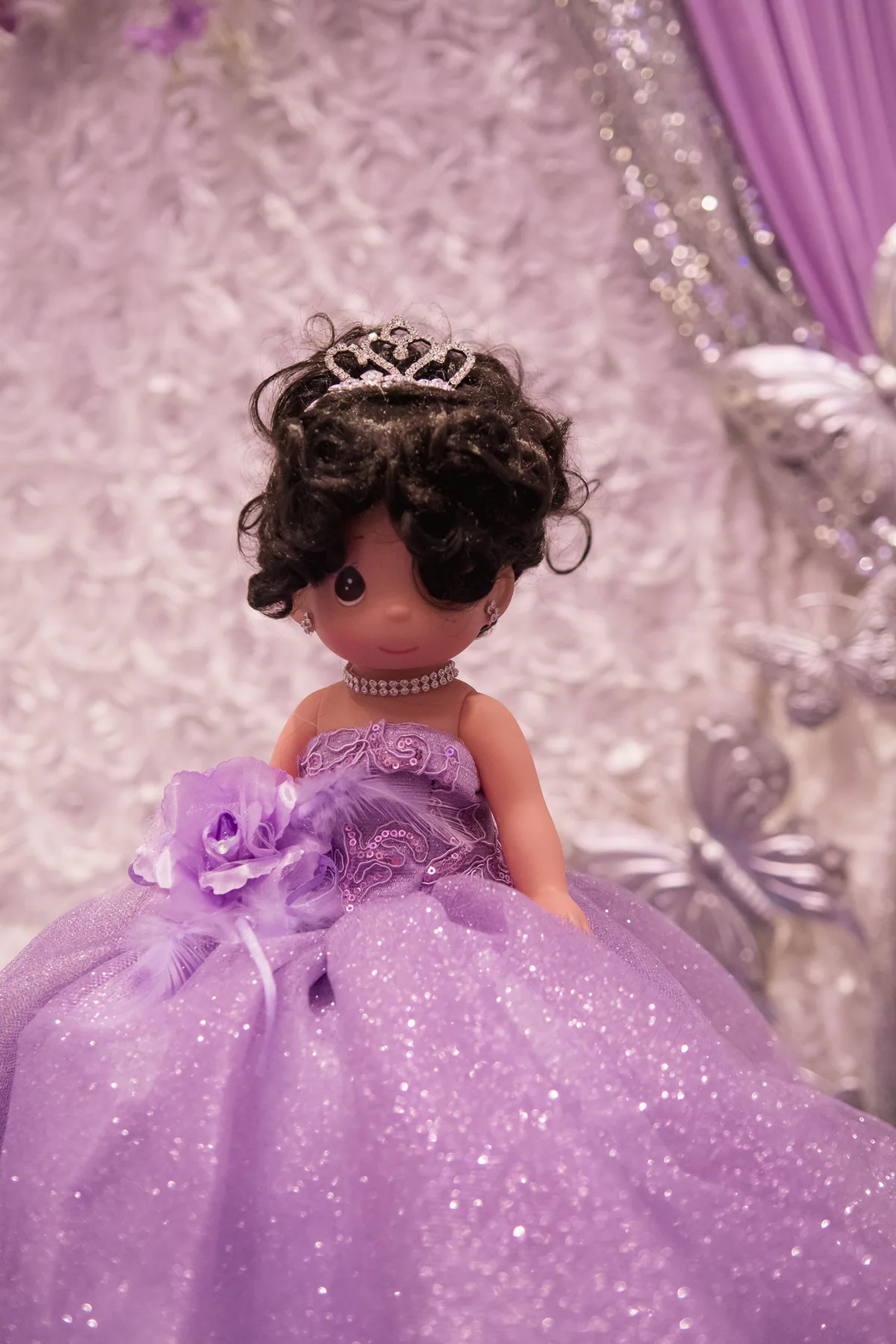 Doll in a sparkling purple ball gown with a small tiara.