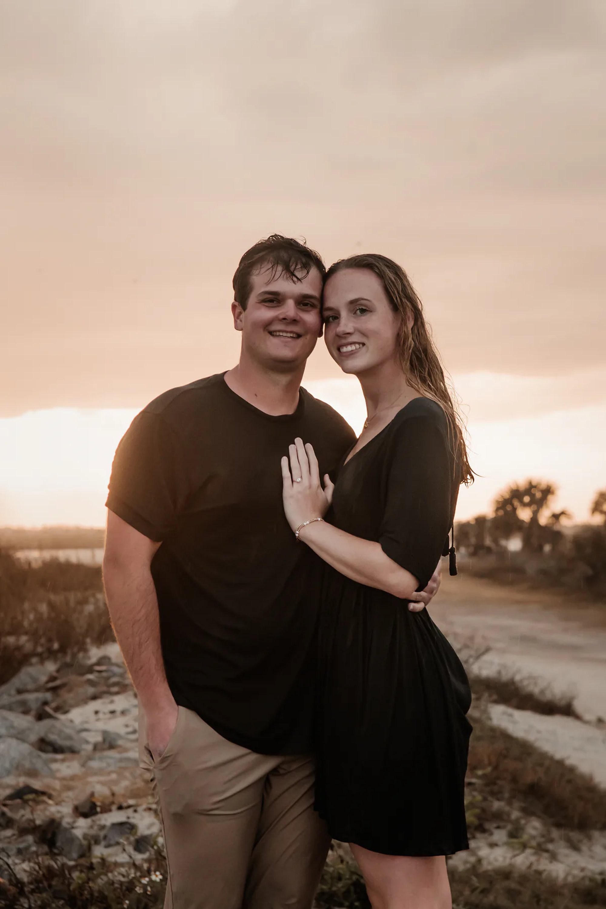 Ponce Inlet engagement portrait of couple smiling together near the water at sunset