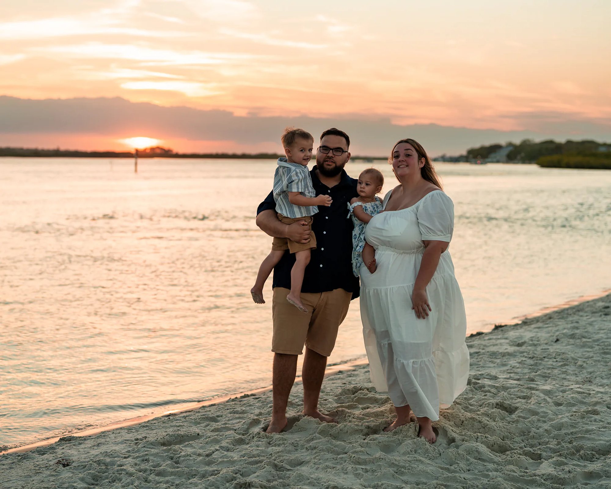 Family portrait by the water during sunset at Ponce Inlet Beach in Volusia County Florida