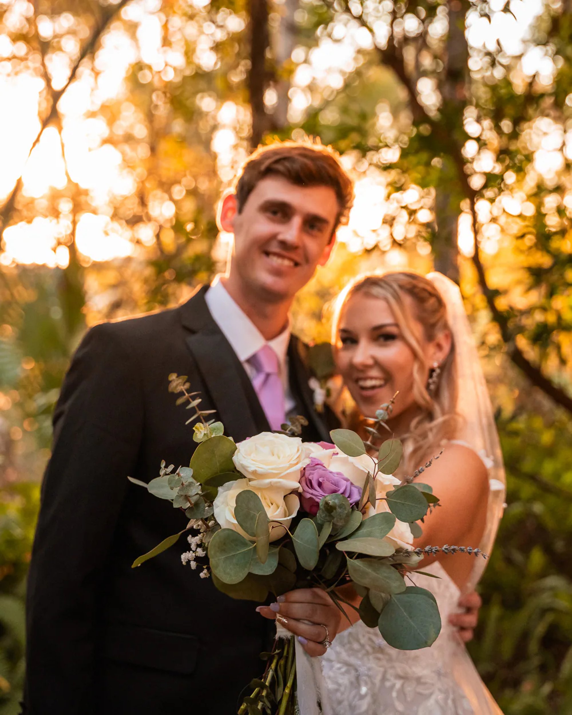 Bride and groom portrait with bouquet during golden hour at Bridle Oaks Barn wedding in DeLand Florida