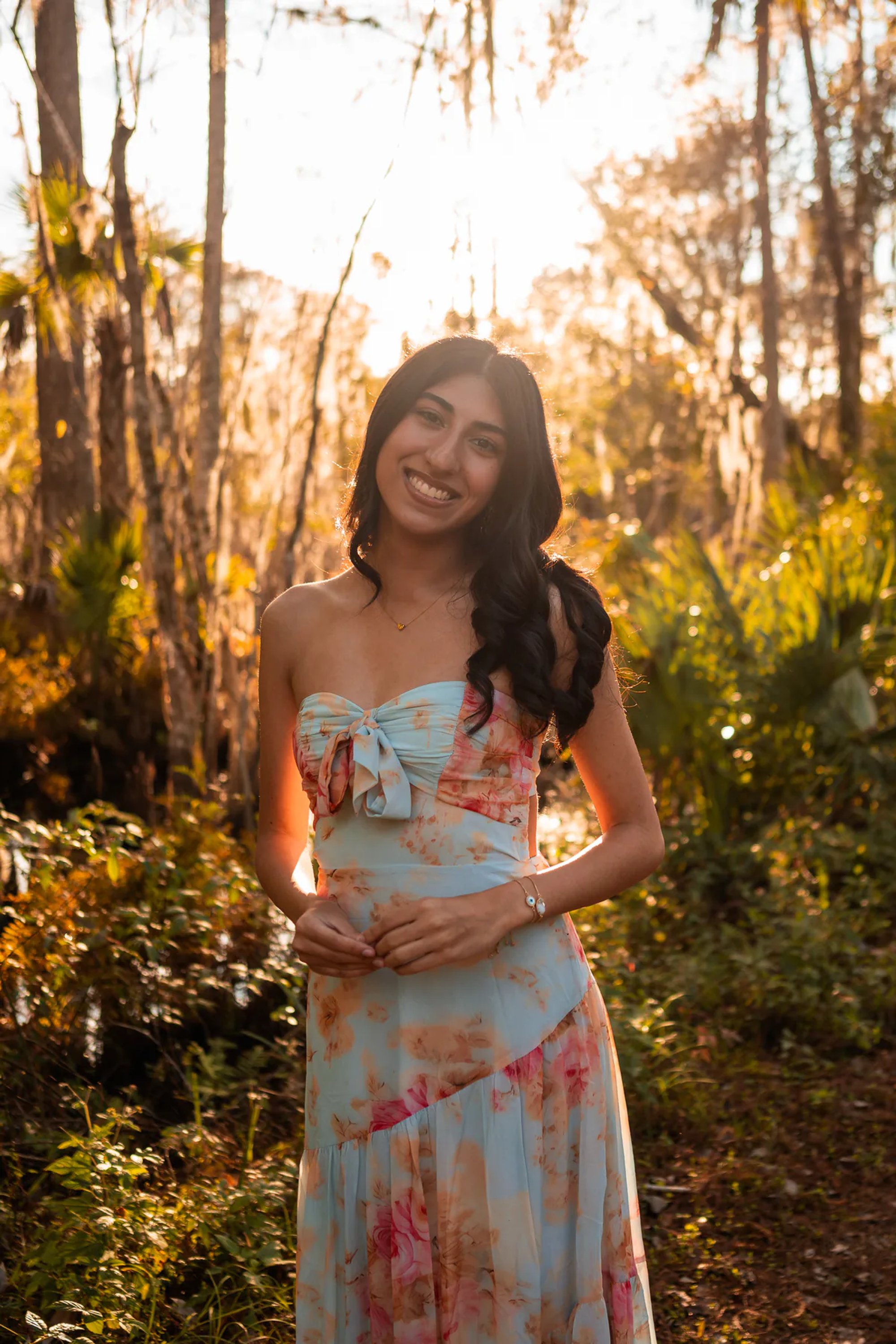 Ahaana standing in soft natural light during senior portraits in Volusia County