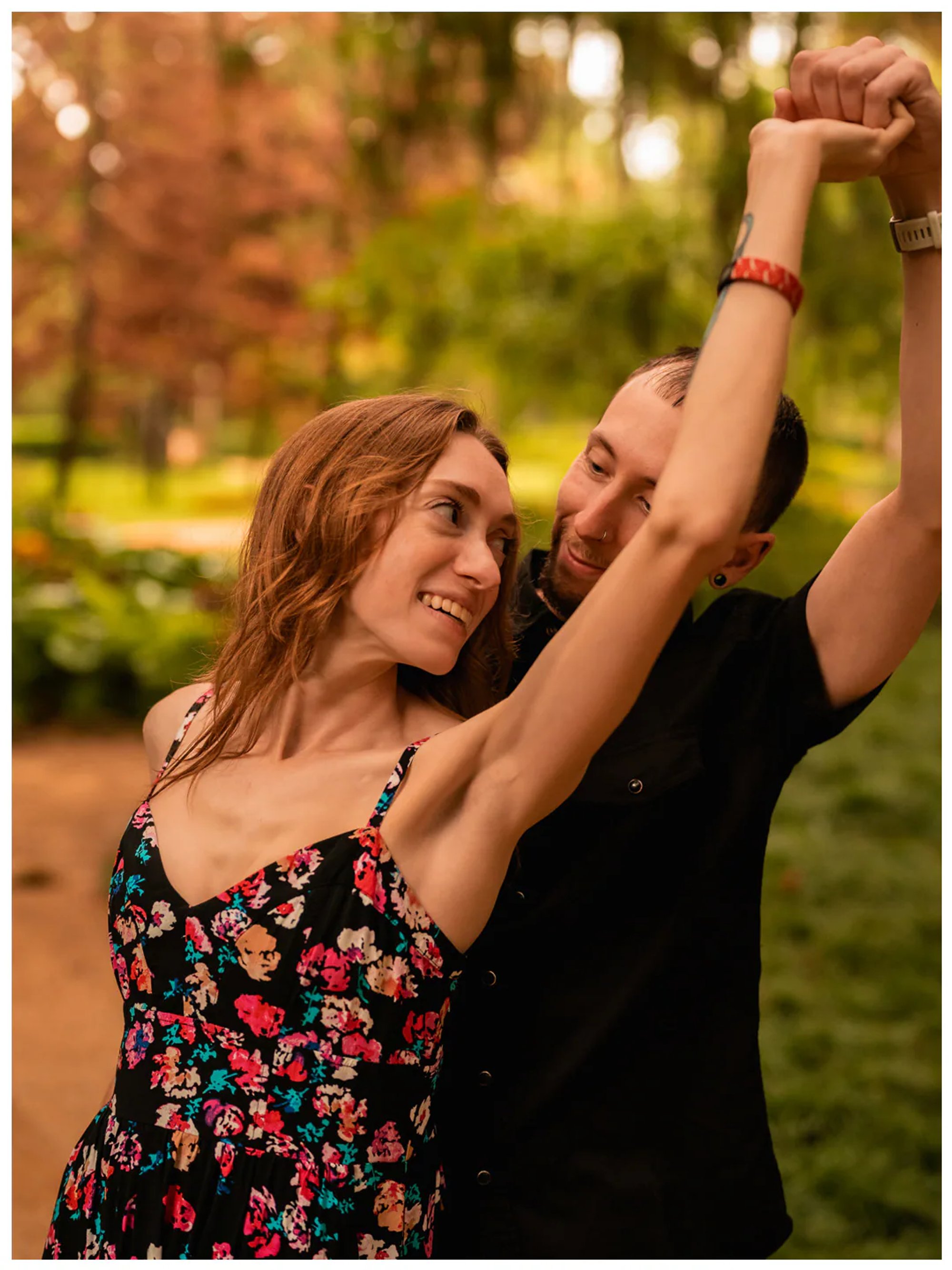 Man twirling his partner with their hands joined at Washington Oaks Gardens State Park.