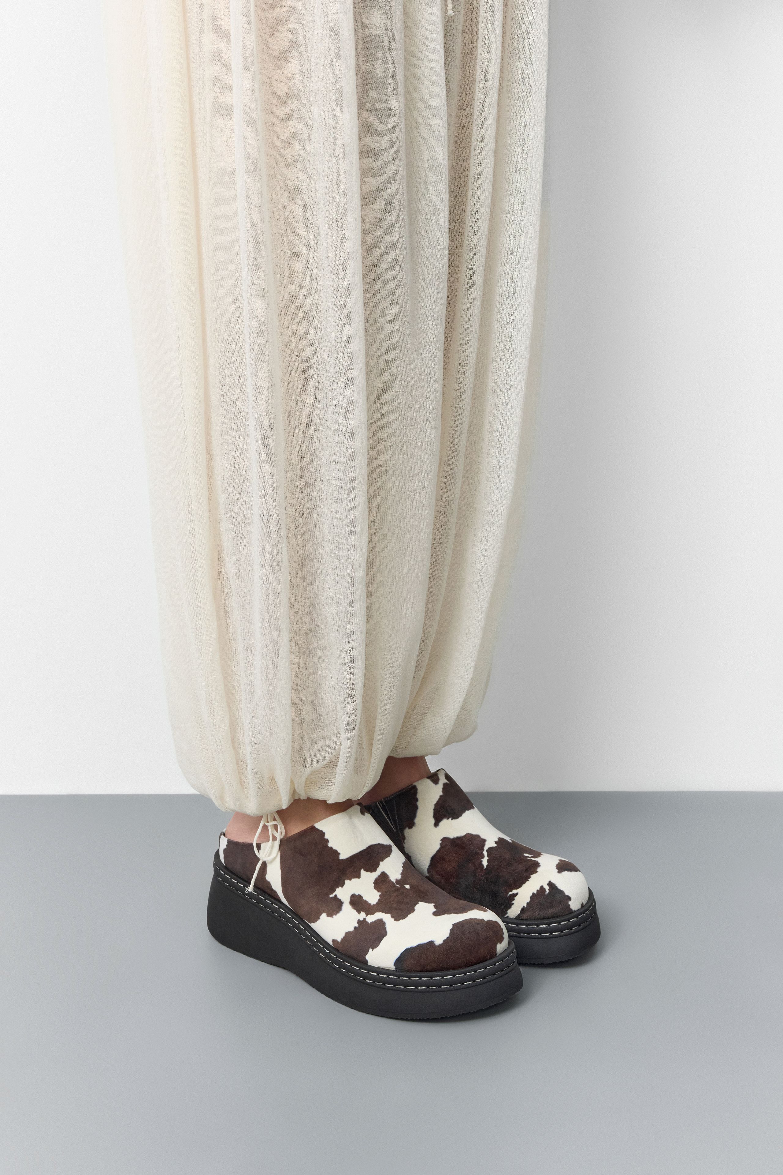 Kristi Mules - Cow Print Faux Suede | Miista