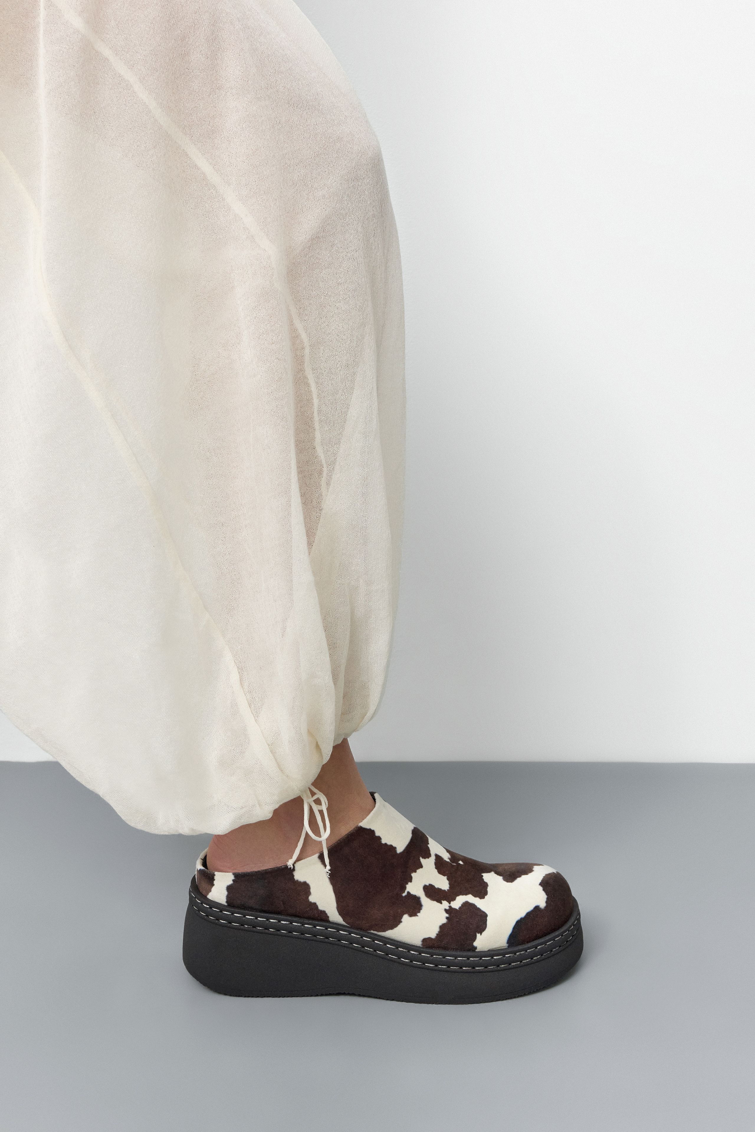 Kristi Mules - Cow Print Faux Suede | Miista