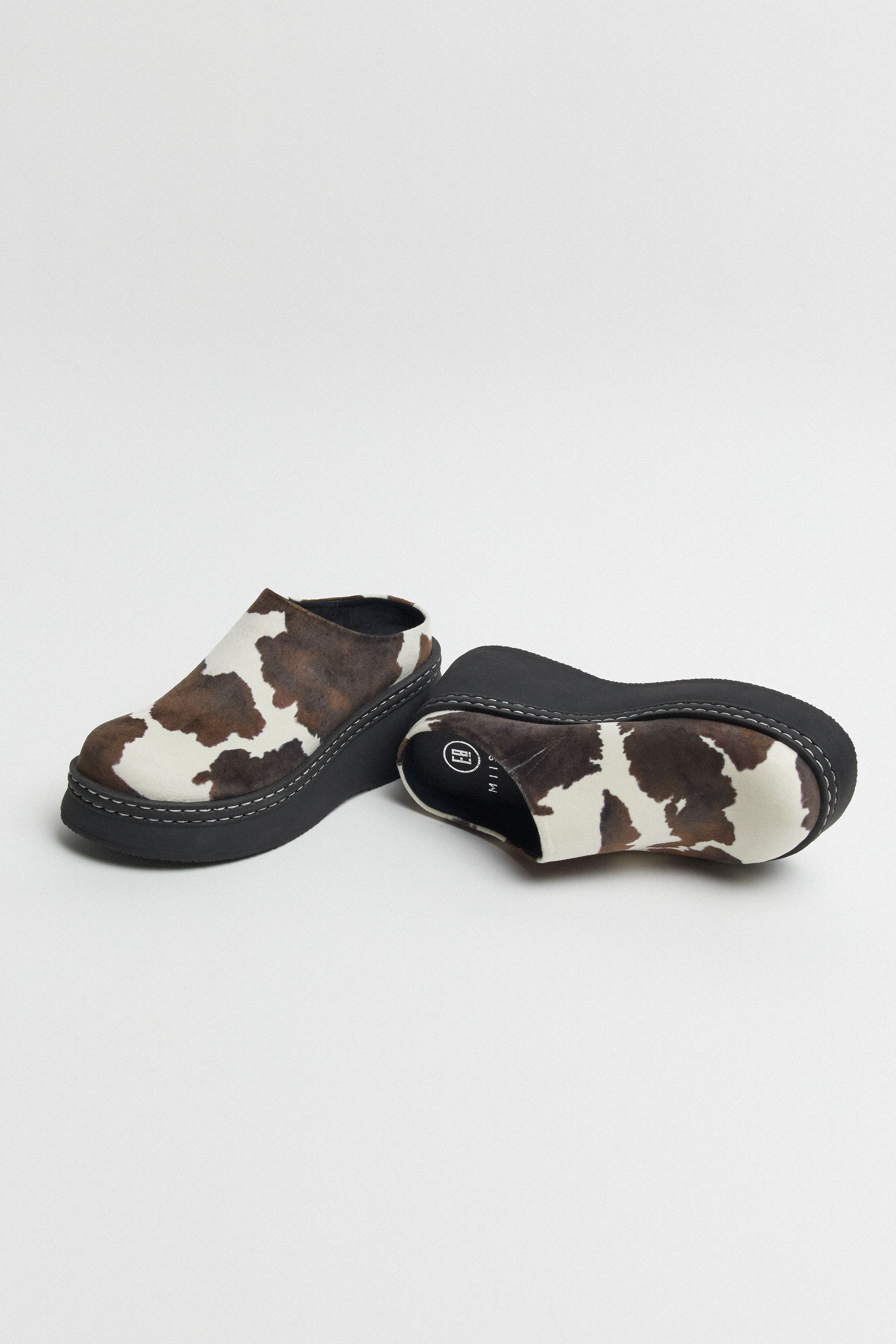 Kristi Mules - Cow Print Faux Suede | Miista