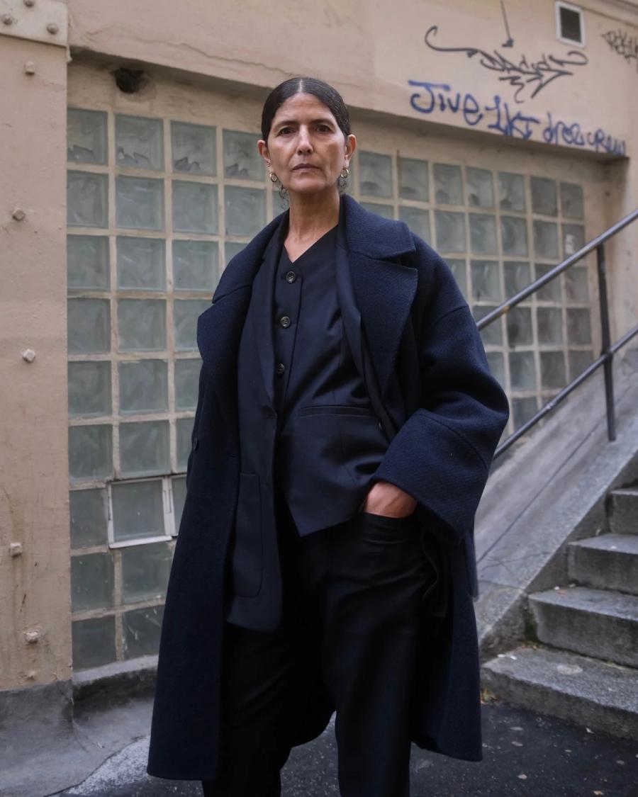 Model wearing an oversized deep navy wool overcoat by sustainable womenswear brand Studio Wylder. The coat features an oversized tailored silhouette, structured construction and a minimalist finish. Studio Iole developed the creative pattern through fittings and refinements, working through to the final sealed production pattern used to produce the finished garment shown.