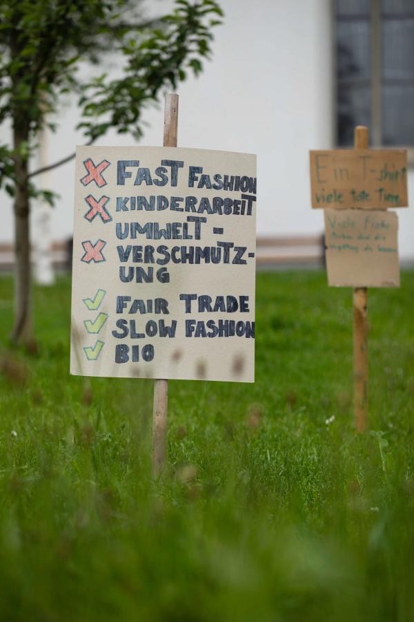 Sustainable fashion activist signs