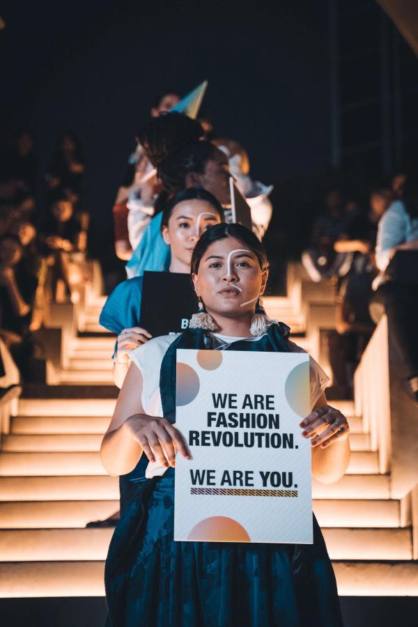 sustainable fashion activists at a fashion protest.