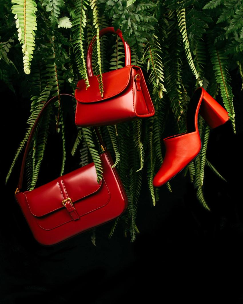 red leather bags and shoe hanging on tree