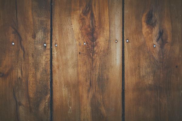 Close-up of three reclaimed wooden floorboards.