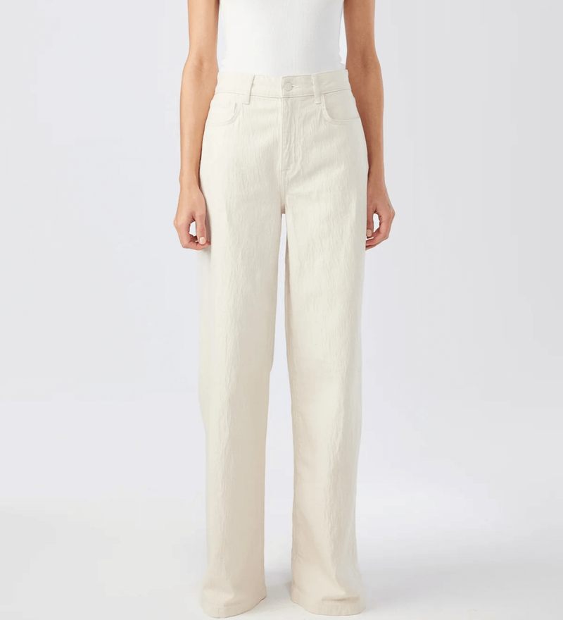 A girl wearing a high rise wide leg pants in off white color.